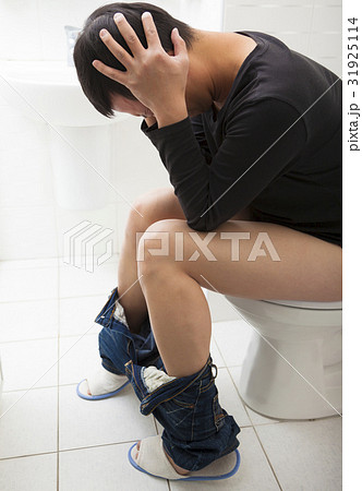 young man sitting toilet seat young man sitting toilet seat 31925114