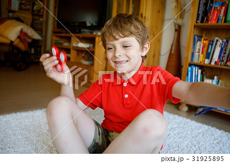 School kid playing with Tri Fidget Hand Spinner School kid playing with Tri Fidget Hand Spinner 31925895