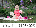 Little girl is playing with flowers, 31934025