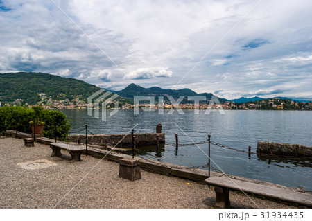 Green mountains and buildings. 31934435