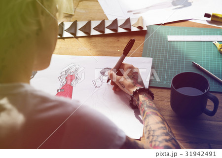 Fashion designer tattooed girl drawing cloth pattern Fashion designer tattooed girl drawing cloth pattern 31942491