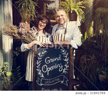 Adult Man and Woman Standing with Grand Opening Sign 31942769