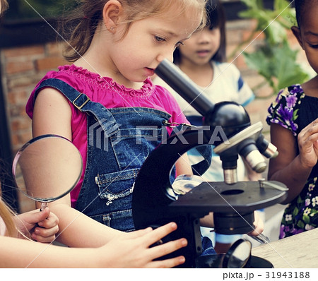 Group of children learning science by microscope Group of children learning science by microscope 31943188