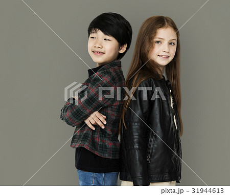 Two kids standing back to back portrait 31944613