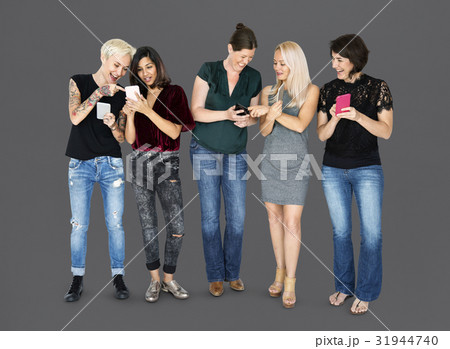 Happiness group of girlfriends smiling and conneted by mobile phone 31944740
