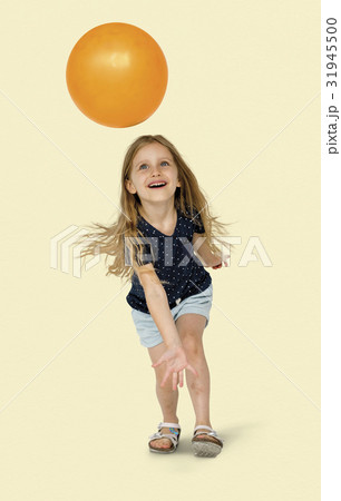 Young caucasian girl with an orange ball Young caucasian girl with an orange ball 31945500