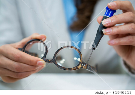 Optician repairing spectacles with tool Optician repairing spectacles with tool 31946215