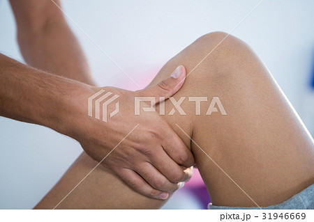 Physiotherapist giving leg massage to a patient Physiotherapist giving leg massage to a patient 31946669