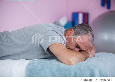 Senior man lying on a massage bed Senior man lying on a massage bed 31946781
