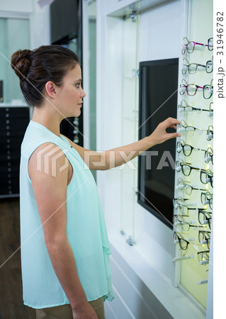 Female customer selecting spectacles Female customer selecting spectacles 31946782