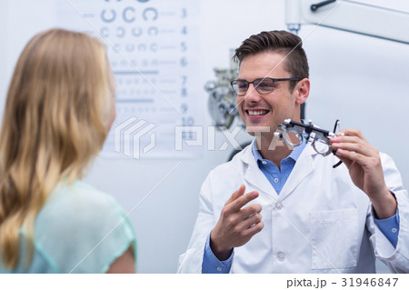 Optometrist discussing on messbrille with female patient Optometrist discussing on messbrille with female patient 31946847