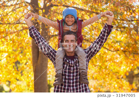 Happy father carrying son on shoulder at park Happy father carrying son on shoulder at park 31947005