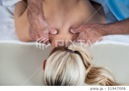 Woman receiving shoulder massage from physiotherapist 31947006