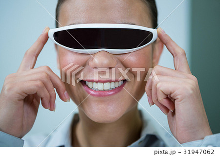 Woman using virtual video glasses 31947062