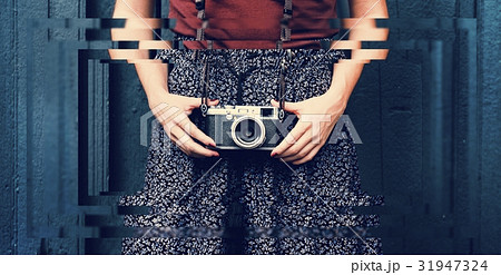Traveler photographer woman holding film camera 31947324