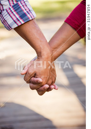 Close up of hiker couple holding hands 31947854