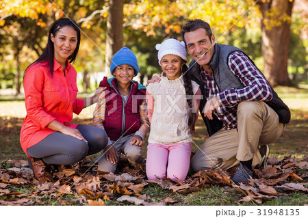 Happy family at park during autumn 31948135