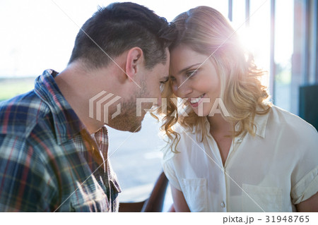 Couple looking face to face in cafeteria Couple looking face to face in cafeteria 31948765