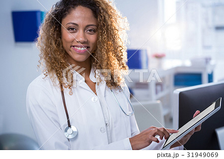 Portrait of smiling physiotherapist using digital tablet Portrait of smiling physiotherapist using digital tablet 31949069