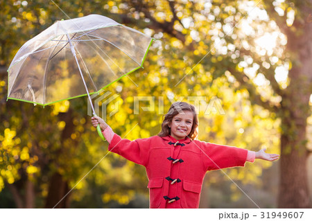Girl playing with umbrella at park 31949607