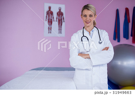 Portrait of physiotherapist standing with arms crossed Portrait of physiotherapist standing with arms crossed 31949663