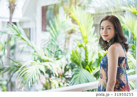 A photo of beautiful woman smiling and standing at balcony 31950255