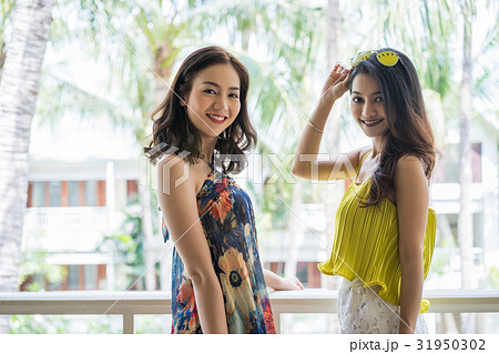 Two beautiful girls are smiling, posing and looking at camera Two beautiful girls are smiling, posing and looking at camera 31950302