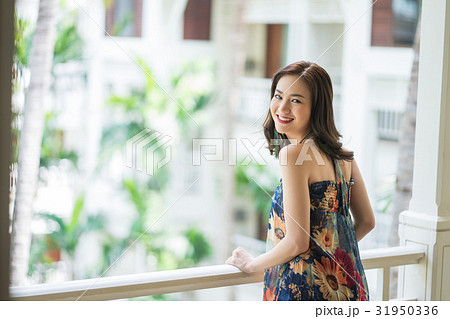 A woman is touching the hand-rail and smiling 31950336