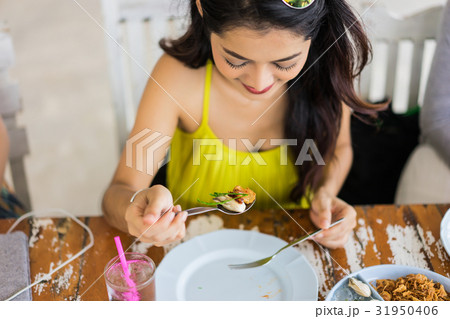 A beautiful woman is having a meal in the restaurant. 31950406