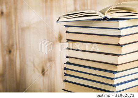 Stack of books on a wooden background. 31962672