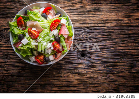 Healthy  salad olives tomatoes parmesan cheese. 31963389