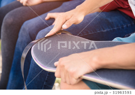 Boy cleans the trimmed edge the griptape on a 31963593