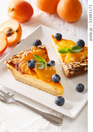 Apricot pie with blueberries and nuts close-up 31965171