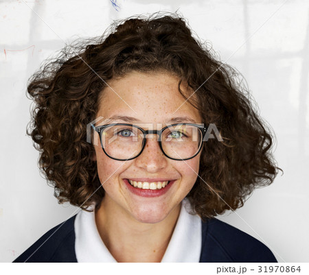 Portrait studio shoot of schoolgirl in uniform with smiling 31970864