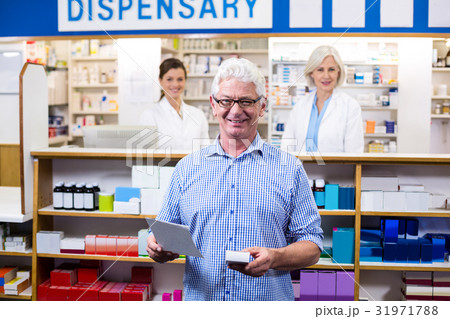 Customer holding prescription while checking medicine in pharmacy Customer holding prescription while checking medicine in pharmacy 31971788