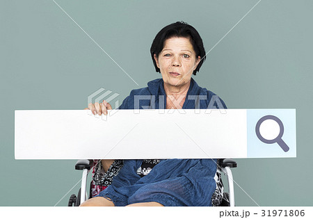 Senior adult woman on wheelchair holding searching banner Senior adult woman on wheelchair holding searching banner 31971806