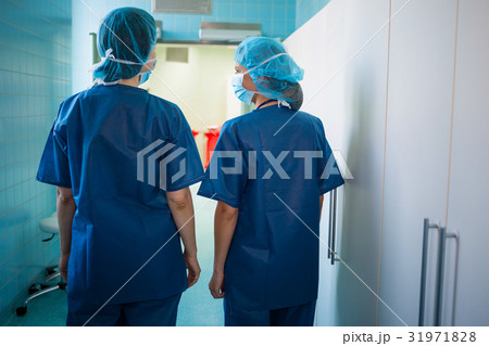 Surgeons standing in corridor at hospital Surgeons standing in corridor at hospital 31971828