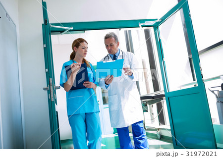 Doctor and nurse checking medical report 31972021