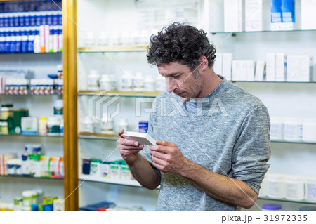 Customer checking a medicine box 31972335