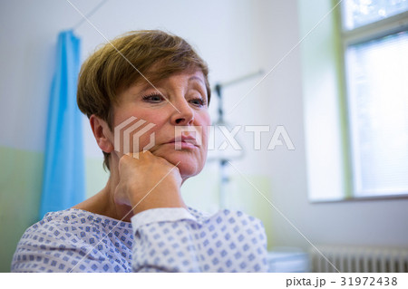 Close-up of sad senior patient sitting on a bed 31972438