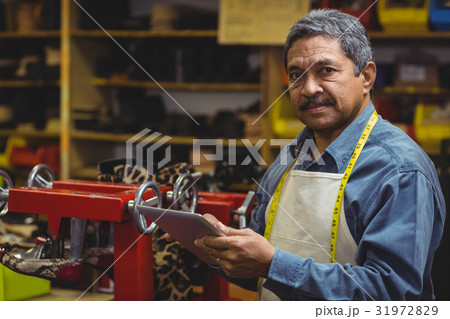 Shoemaker using digital tablet Shoemaker using digital tablet 31972829