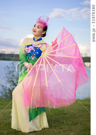 chinese girl in traditional chinese dress with fan chinese girl in traditional chinese dress with fan 31976380