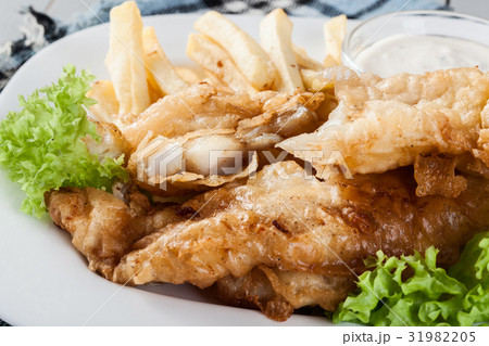 Fish and chips with tartar sauce on a plate Fish and chips with tartar sauce on a plate 31982205