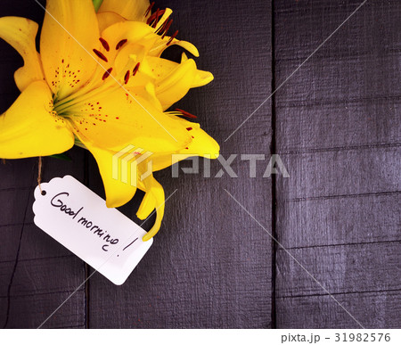 Yellow lily and a paper tag Yellow lily and a paper tag 31982576
