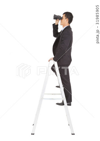 businessman using a pair of binoculars standing  31985905