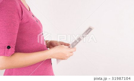 Pregnant asian woman looking at ultrasound film 31987104
