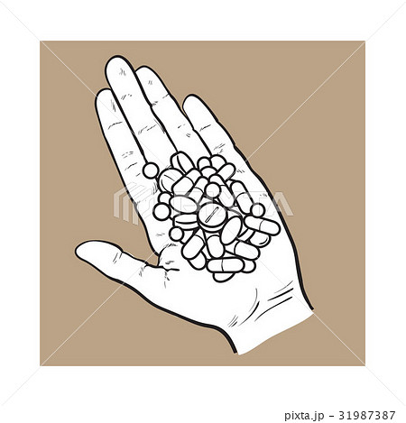 Hand holding pile ofpills, tablets in open palm 31987387