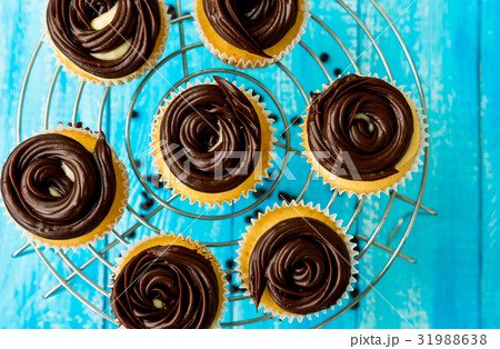 Tasty cupcakes on the blue background 31988638