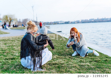 Two women and a little boy on the lake 31993245