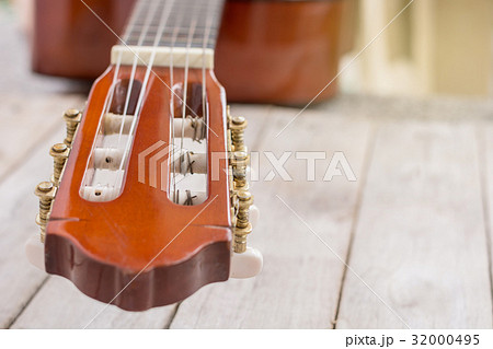 close-up of classic guitar headstock on wooden 32000495
